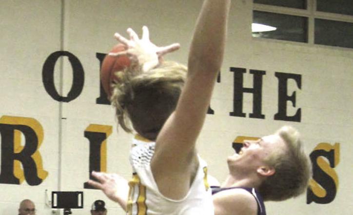 Oelwein's Camren Palmer shoots against Wapsie Valley's Kiks Rosengarten